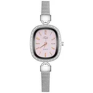 Close-up of women's silver mesh watch with pink shell dial and rhinestone bezel