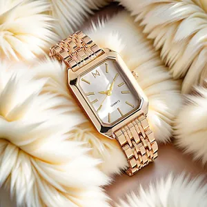 Macro view of a rose gold octagonal quartz watch with a white dial and steel bracelet