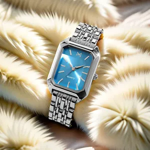 Detailed macro of a silver quartz watch with a sunray blue dial on white faux fur background