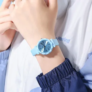 Detailed view of blue quartz watch featuring faceted diamond-cut bezel and silicone strap