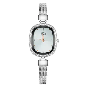 Detail of silver quartz watch featuring oval rhinestone bezel and mesh metal strap