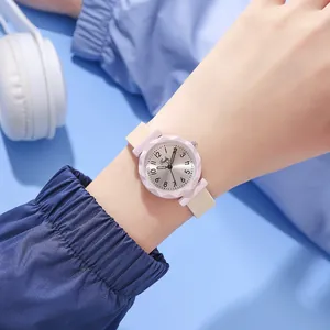 Close-up of women's quartz watch featuring a pink faceted bezel and two-tone silicone strap