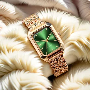 Detail of emerald green sunray dial and gold link strap on elegant quartz watch