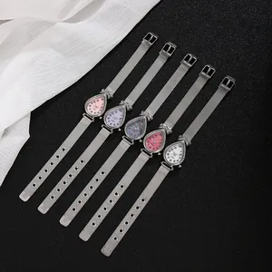 Detail showing five teardrop quartz watches with rhinestone bezels and mesh straps