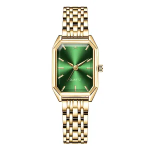 Close-up of emerald green sunburst dial and gold steel watch band for women