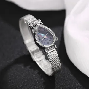 Macro view of teardrop quartz watch with diamond bezel and silver mesh band detail