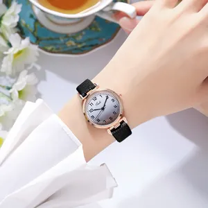 Close-up of women's watch with gradient dial, Arabic numerals and black woven strap