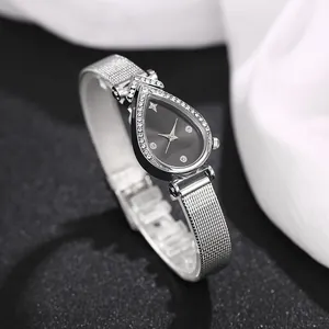 Macro view of teardrop watch face with crystal bezel and black minimalist dial