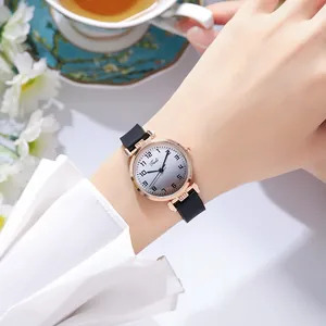 Close-up of elegant gradient dial watch with rose gold case and black leather strap