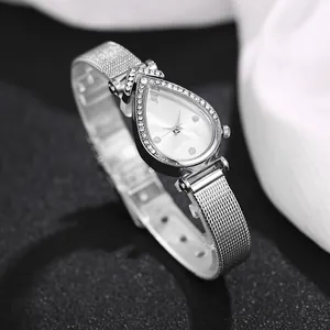 Detail of silver water-drop watch case with sparkling rhinestones and mesh band