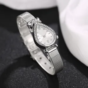 Macro detail of teardrop quartz watch with crystal bezel and silver mesh strap