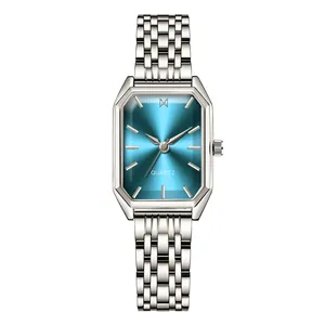 Close-up of elegant silver quartz watch featuring an emerald-cut teal sunray dial