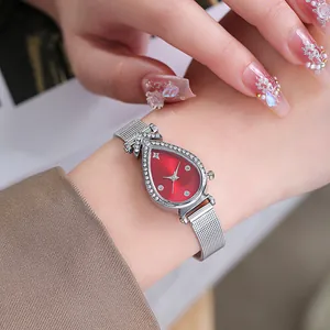 Close-up of woman wearing water-drop watch with red dial and silver magnetic mesh strap