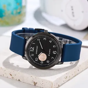 Detail view of quartz watch with black dial and navy blue silicone strap on stone base