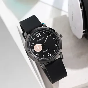Detailed close-up of a minimalist quartz watch with black silicone strap and numeric dial
