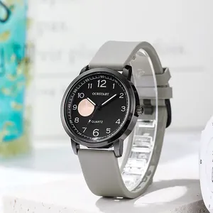 Macro detail of quartz watch featuring gray silicone strap and minimalist black round dial