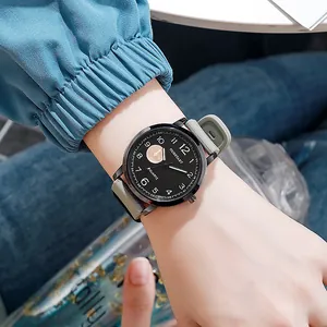 Stylist quartz watch with black dial and grey-green silicone strap on human wrist
