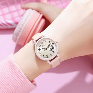 Close-up of pink leather strap watch with butterfly dial and champagne gold finish