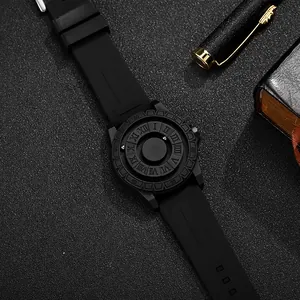 Detail of matte black magnetic watch with rolling balls showing roman numeral markers