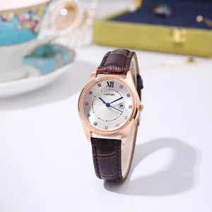 Detailed close-up of rose gold watch face with crystal indices and brown leather strap