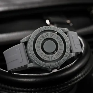 Macro shot of magnetic ball bearings and embossed Roman numerals on a matte grey watch