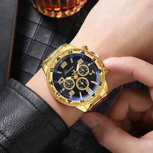 Macro detail of the Ganwa gold engraved steel watch featuring a black three-eye dial design