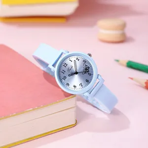 Detail view of a light blue student quartz watch with butterfly dial in a cute setup