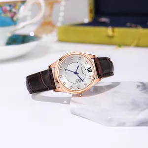 Detailed view of women's watch featuring a sunburst dial with rhinestones and leather strap