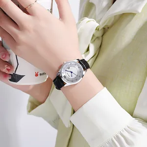 Close-up of a women's quartz watch with black leather strap and sunray roman numeral dial