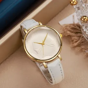 Detail of white leather watch strap with crocodile pattern and golden metal watch case