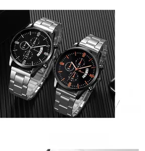 Detail of two business men's quartz watches with stainless steel bands and calendar windows
