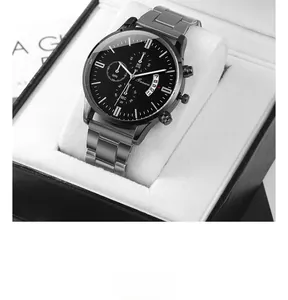 Detail shot of black quartz watch with three sub-dials and date window in a luxury gift box