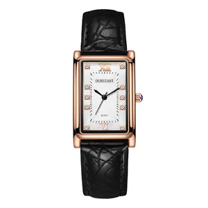 Detail of elegant rectangular rose gold watch with crystal indexes and black leather strap