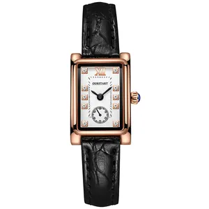 Detailed close-up of a square rose gold watch with white dial and black leather strap