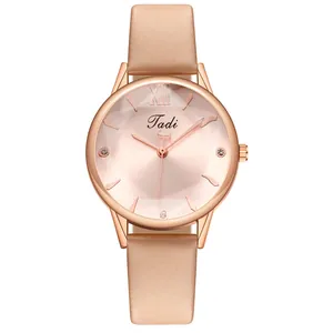 Detailed view of rose gold fashion watch with diamond markers and satin fabric strap
