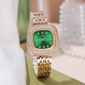 Detail of a ladies' green sunray dial watch with sparkling crystal bezel and two-tone band