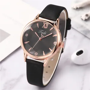Detail of rose gold watch case with black sunray dial and diamond-like hour markers