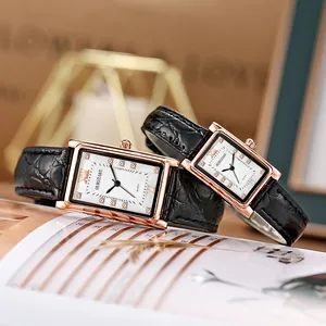 Detail view of the pair of rose gold square quartz watches with black leather straps