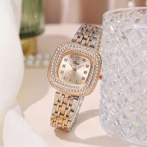 Close-up of square rhinestone bezel quartz watch with two-tone steel link bracelet