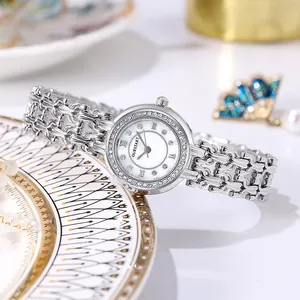 Close-up of elegant women's watch with mother-of-pearl dial and crystal bezel on ceramic