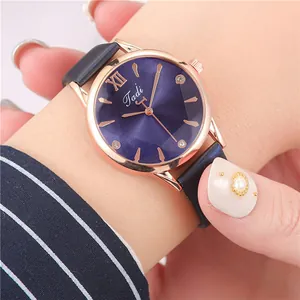 Close-up of Tadi women's quartz watch with blue sunray dial and rose gold case