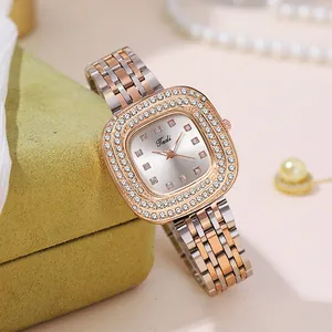 Macro view of rose gold dual-tone watch with double diamond bezel on velvet cushion