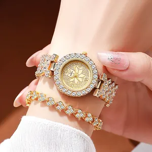 Close-up of a women's gold-tone watch and heart bracelet set with sparkling rhinestones