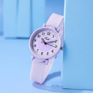 Close-up of a minimalist purple quartz watch with silicone strap and numeric dial