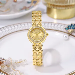 Detailed macro of gold watch with mother of pearl dial and crystal bezel in a dish