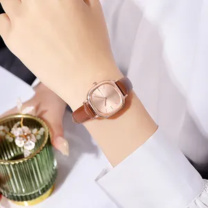 Minimalist rectangular rose gold quartz watch with premium brown leather strap on wrist