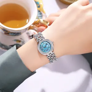 Close-up of elegant women's watch with sky blue mother-of-pearl dial and crystal bezel