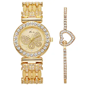 Detailed view of women's gold watch with rhinestone butterfly dial and heart bracelet
