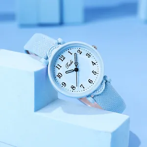 Macro detail of Tadi light blue watch face with Arabic numerals and clean dial texture