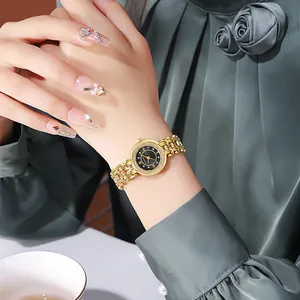 Close-up of golden luxury women's watch with woven metal strap and diamond bezel detail